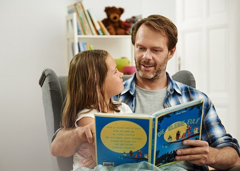 Kompaktmedien und familie redlich entwickeln Kampagne 'Lesen & Schreiben' weiter - Der Tochter vorlesen: Die neuen Motive zeigen Beispiele dafür, was Menschen gewinnen, wenn sie besser lesen und schreiben können (Foto: Andreas Pollock)